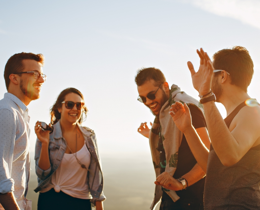 Adults with sunglasses laughing